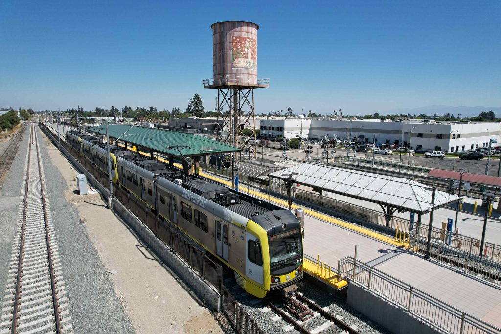 An aerial photograph of a train pulled into the platform at the Pomona North Station.